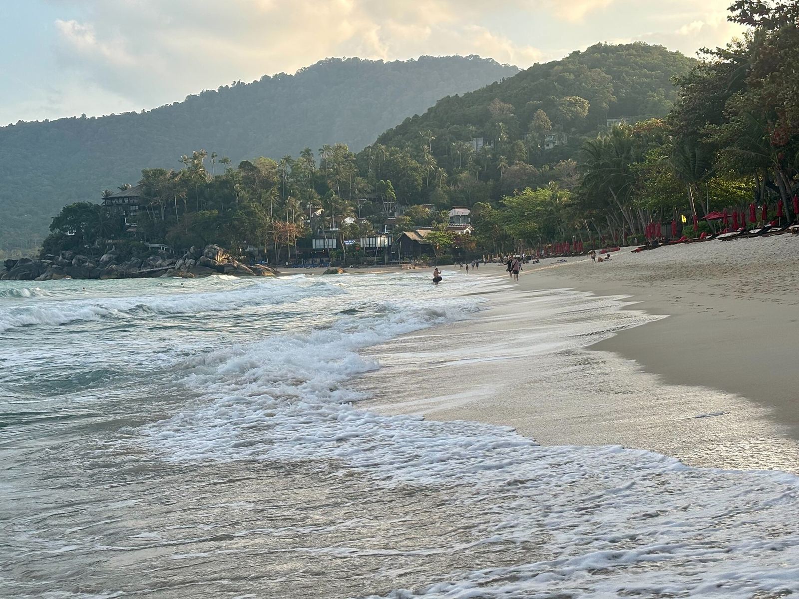 Waves on the sand at Thong Nai Pan beach with jungle-covered hills behind, north-east Koh Phangan
